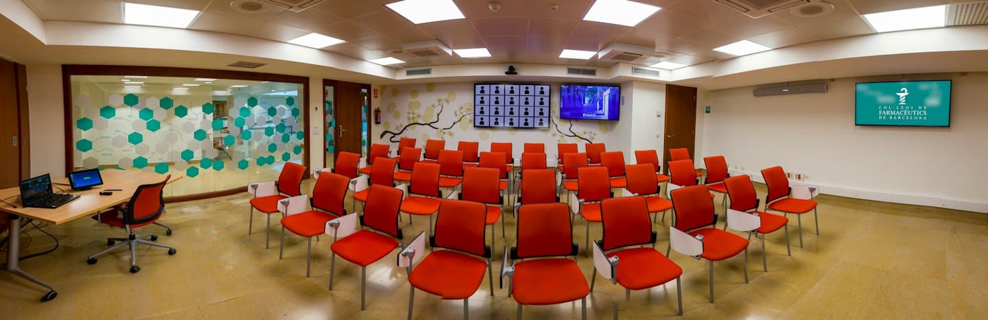 Modern conference room with chairs and presentation screens.